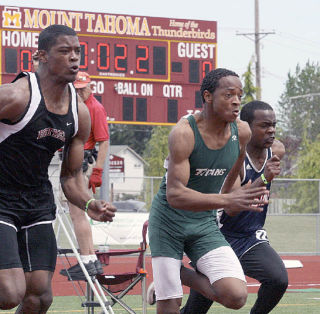 Todd Beamer High School senior Josh Waller (middle) runs a preliminary race in the 100 meters Friday afternoon at the West Central District Track and Field Championships at Mount Tahoma High School. Waller will compete at Friday and Saturday’s state championships in the triple jump.