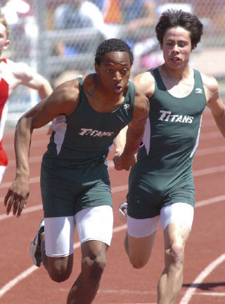 Todd Beamer High School 4x100 runners Josh Waller (left ) and Justin Drayer make a handoff during the Titans’ state championship winning run at the Class 4A State Track and Field Championships in Pasco. The Titans outleaned second-place Cascade in the race.