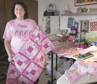 Jeri Worklan-Eubanks holds a quilt she will give to a breast cancer survivor June 21 at the Puget Sound Race for the Cure.