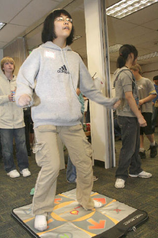 Fifteen-year-old Erica Huang competes with another teen playing “Dance Dance Revolution” at the Federal Way 320th Library Game On Tournament for teens. The Federal Way 320th Library will host video game events from 4 to 5:30 p.m. July 17 and July 24 at the 848 S. 320th St. Every other Thursday afternoon