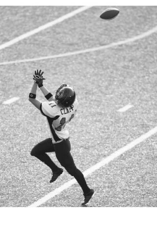 Wide receiver Karlene Clapp of Kent reaches to catch a pass during a Seattle Majestics practice last month. As the state’s only all-women tackle football team