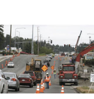 Motorists were backed up from Pacific Highway South to 1st Avenue South midday Tuesday as a crew activated a traffic light. The project is due for completion in September.