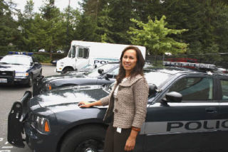 Federal Way police recruiter Catriona Siver stands with a new patrol car. “We’re always in competition with other departments for new officers