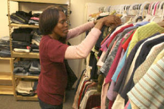 Margaret Hutcheson looks through clothing in search of uniforms for her children Aug. 19 at the Clothing Resource Center. The center was recently reopened and provides free clothing to students in the Federal Way School District.