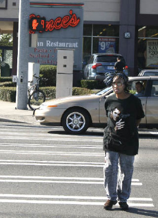 Betty Taylor of Federal Way uses a crosswalk at South 324th Street and Pacific Highway South. Taylor suggested the city council install timed crosswalk signals after she saw the devices last year in Washington
