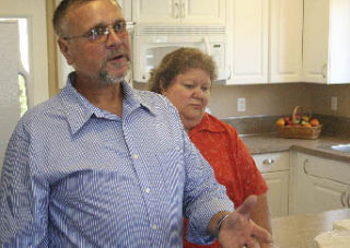 Steven and Lisa Noyes speak at an open house Sept. 13 to celebrate The Joseph Foundation’s new housing unit in Northeast Tacoma. The unit on 48th Avenue Court NE will assist a homeless family in need.