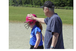 Bob Stewart congratulates his granddaughter Hailey Maher in the summer of 2007. Stewart coached Maher’s fastpitch team and coached the Federal Way baseball team for nearly 20 years.