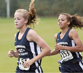 Beamer junior Taylor Kartes overtakes freshman teammate Sara Mussa during a meet Wednesday at Celebration Park against Rogers and Spanaway Lake. Kartes won the girls race in a school-record time of 19:58.