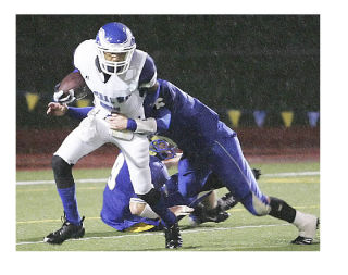 Federal Way wide receiver Nico Curran tries to run out of the tackle of Tahoma defender Mac Bowman during Friday night’s 35-3 Eagle win at Maxwell Stadium in Maple Valley. The win improved the Eagles to 4-1 on the season and was the first loss of the year for Tahoma.