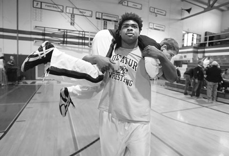 Decatur junior 285-pounder Tevyn Tillman warms up before a match during Saturday's South Puget Sound League North Division Tournament at Kent-Meridian High School. Tillman won the 285-pound championship after Kentridge's Le'Roi Edwards injury defaulted in the final match.