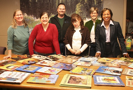 Members of the Federal Way Diversity Commission pose Feb. 13 with books that they will donate to three Federal Way elementary schools.