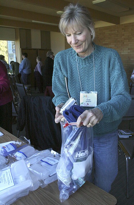 Debi Dopps fills a bag with toiletries and other items for homeless women in Federal Way.