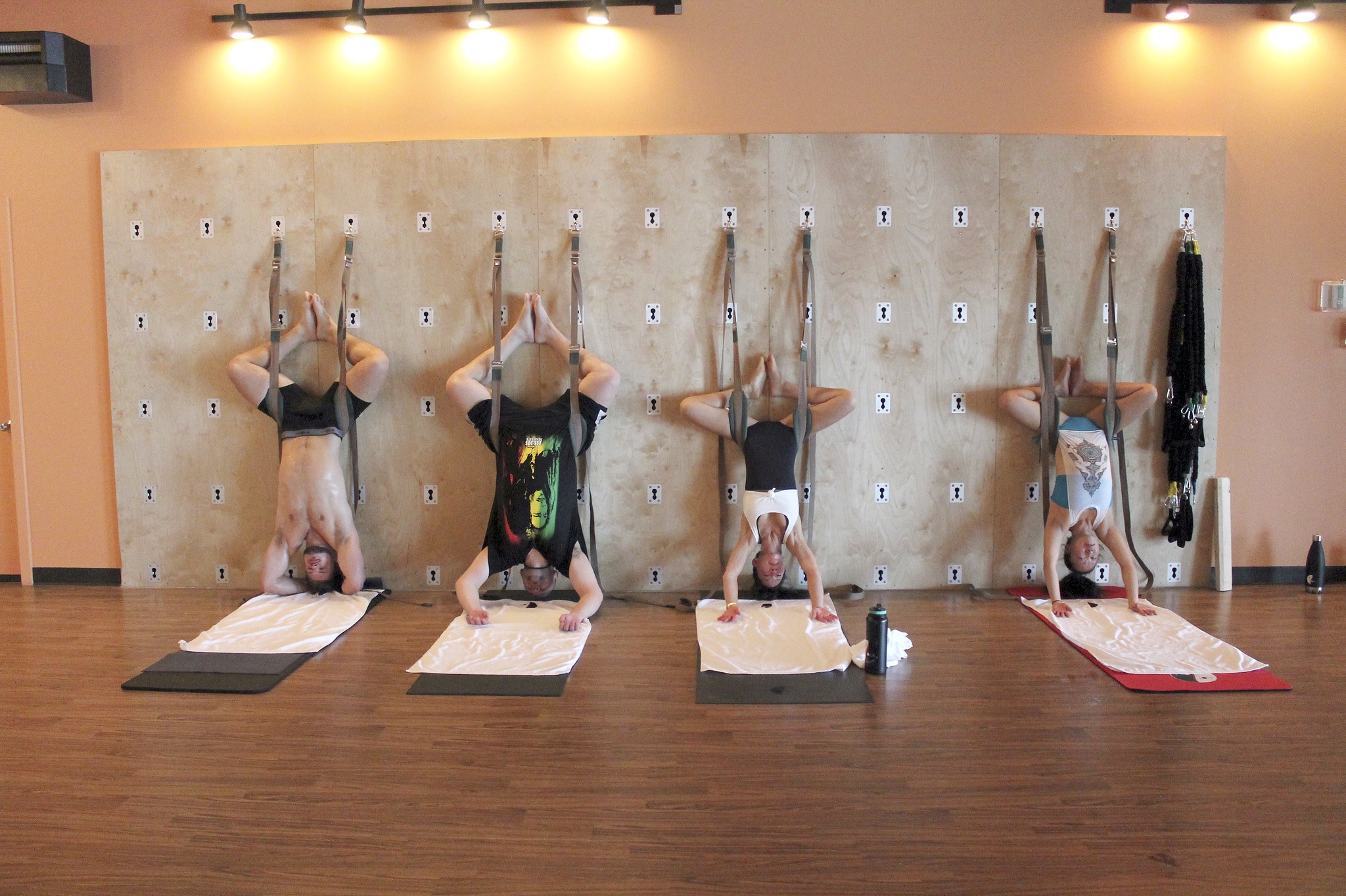 Three Hot Yoga regulars get to experience the yoga wall for the first time with owner and CEO Linda Burch. JEROD YOUNG