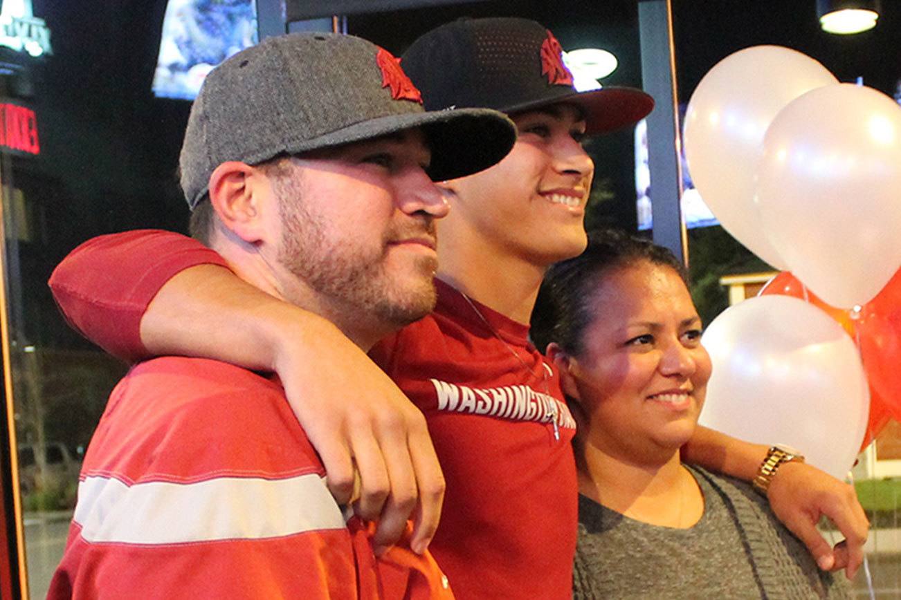 Mason Delacruz poses with his parent after signing his letter of intent to play baseball for Washington State next year. JEROD YOUNG, the Mirror