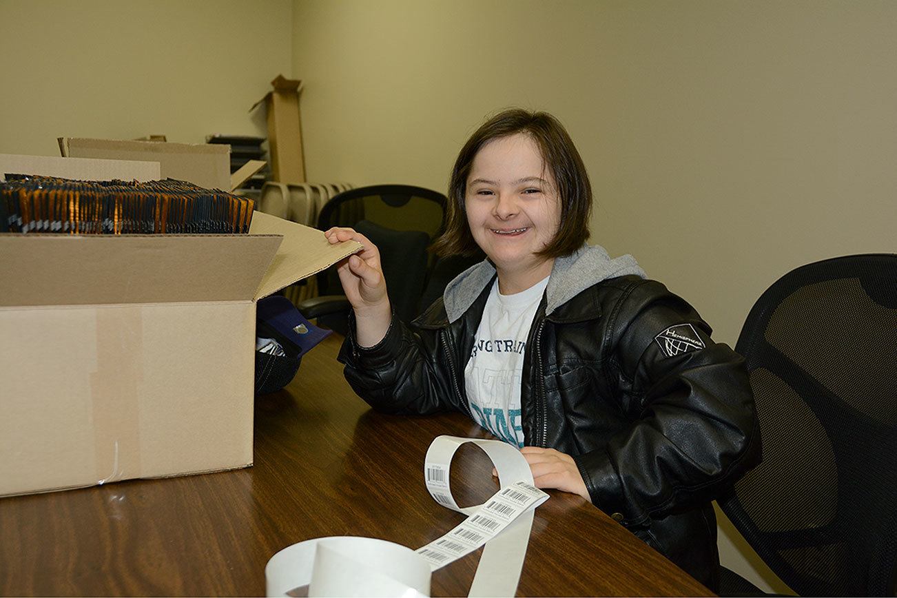 Morgan Kenske, 19, does labeling and stuffs envelopes on Oct. 27 at Caffe D’arté. Photo courtesy of Rick Priest