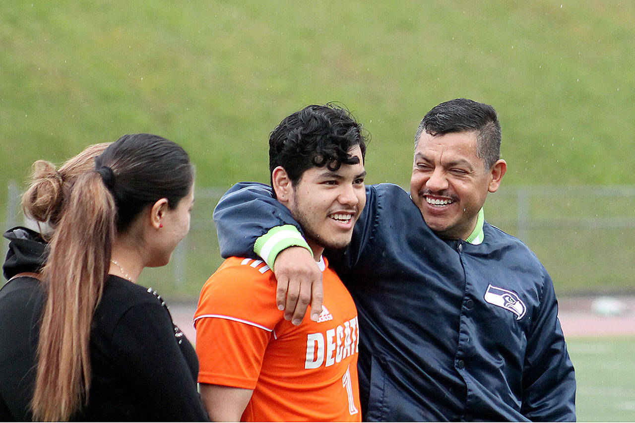 Jose Barbosa and his family are all smiles as the senior is honored on senior day versus Enumclaw on April 25. JEROD YOUNG, the Mirror