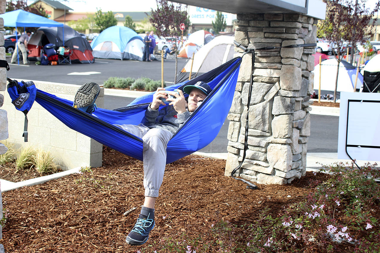 Federal Way resident Tyler Slaeker relaxes on a hammock he set up Wednesday outside the new Federal Way Chick-fil-A, 32025 Pacific Highway S. The restaurant officially opens its doors to the public at 6:30 p.m. Thursday, Sept. 14. Photos by Andy Hobbs, the Mirror