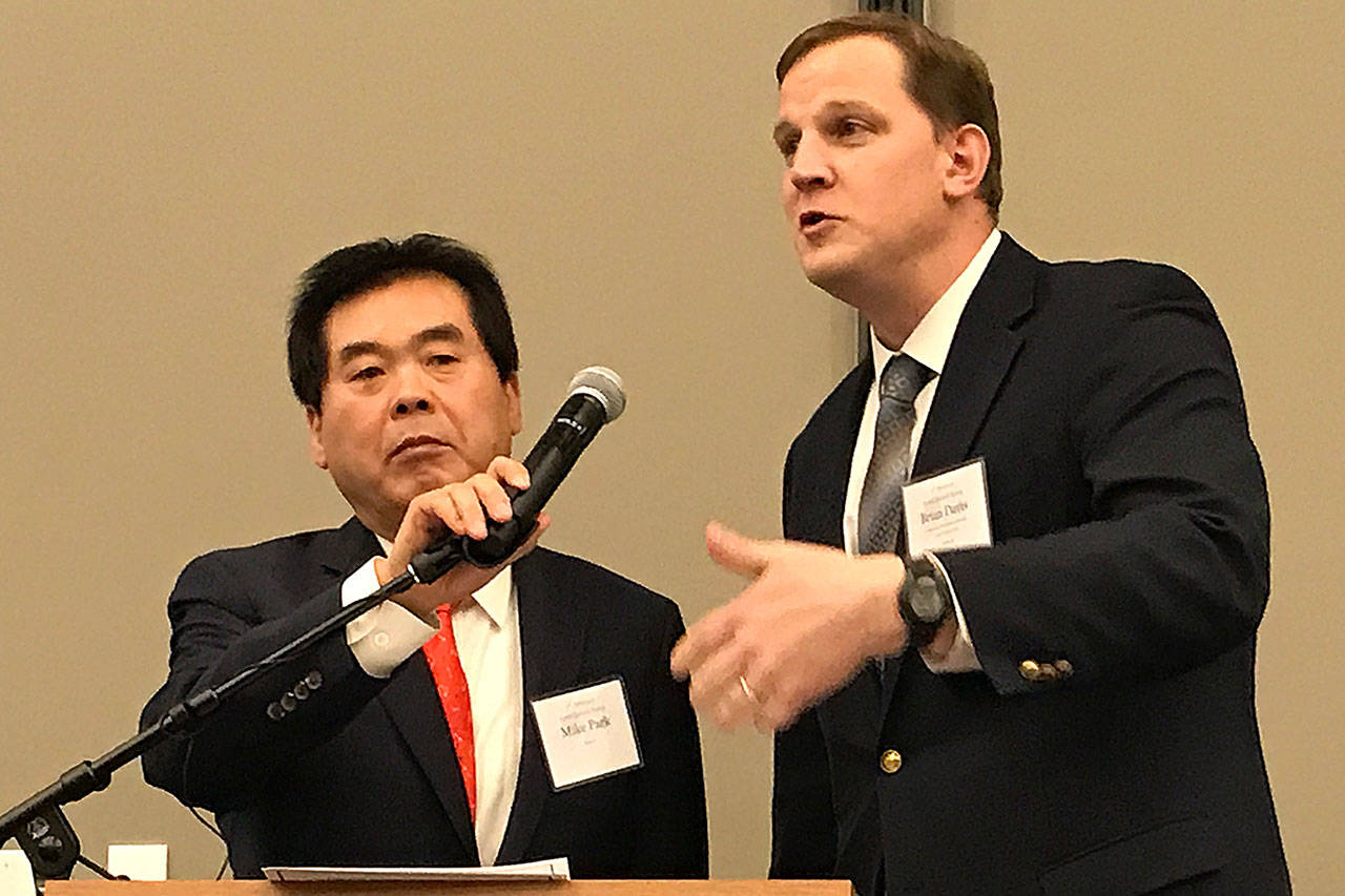 Former Federal Way Mayor Mike Park, left, translated updates on local programs from city officials including Community Development Director Brian Davis. Photo by Andy Hobbs, the Mirror