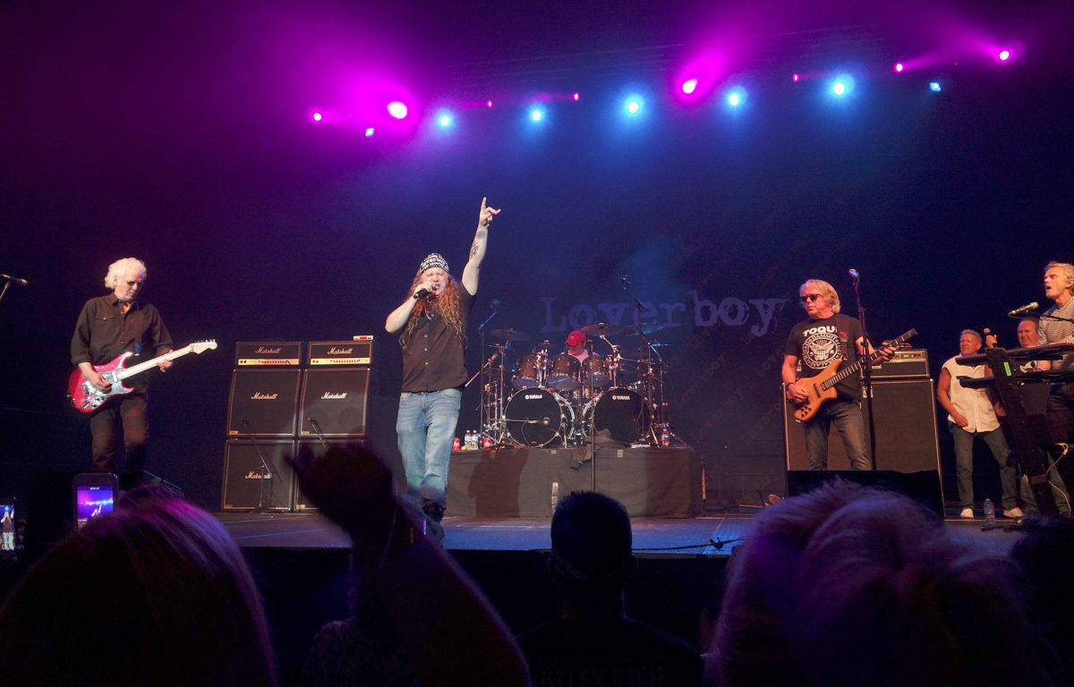 Federal Way resident Steve Fournier raises his hand as he sings with the band Loverboy, whose lead singer, Mike Reno, announced he was too sick to continue after a couple of songs, at Xfinity Arena on Sept. 22. (Courtesy photo)
