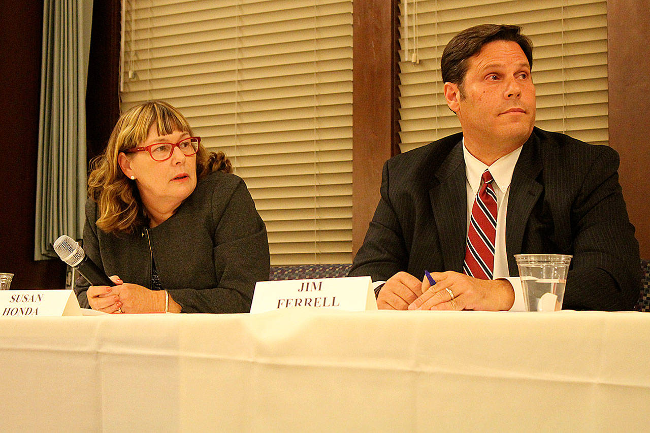 Councilwoman Susan Honda and Mayor Jim Ferrell listen to instructions from moderator T.M. Sell during a forum featuring the mayoral and city council candidates Oct. 11 at Twin Lakes Golf and Country Club. The forum was sponsored by the Federal Way Mirror. (Photo by Andy Hobbs, the Mirror)