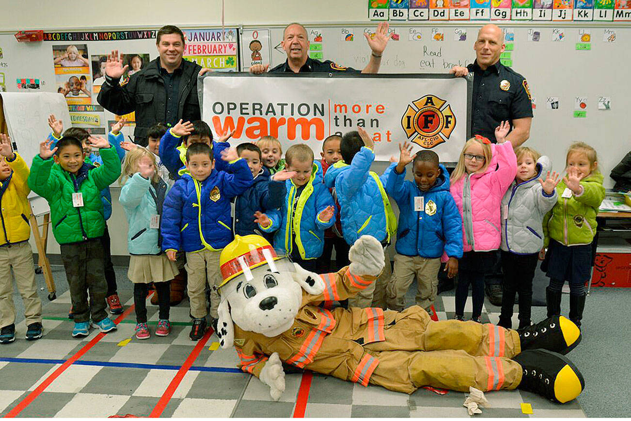 SKFR firefighters present young Mirror Lake students with coats for winter