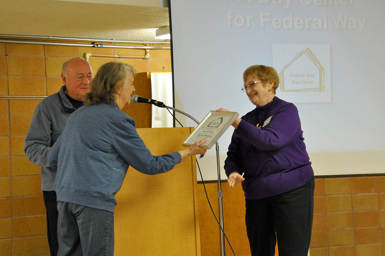 Trese Graddon, right, presents Wanda Manseau, with an award for her service to the Federal Way Day Center. Heidi Sanders, the Mirror