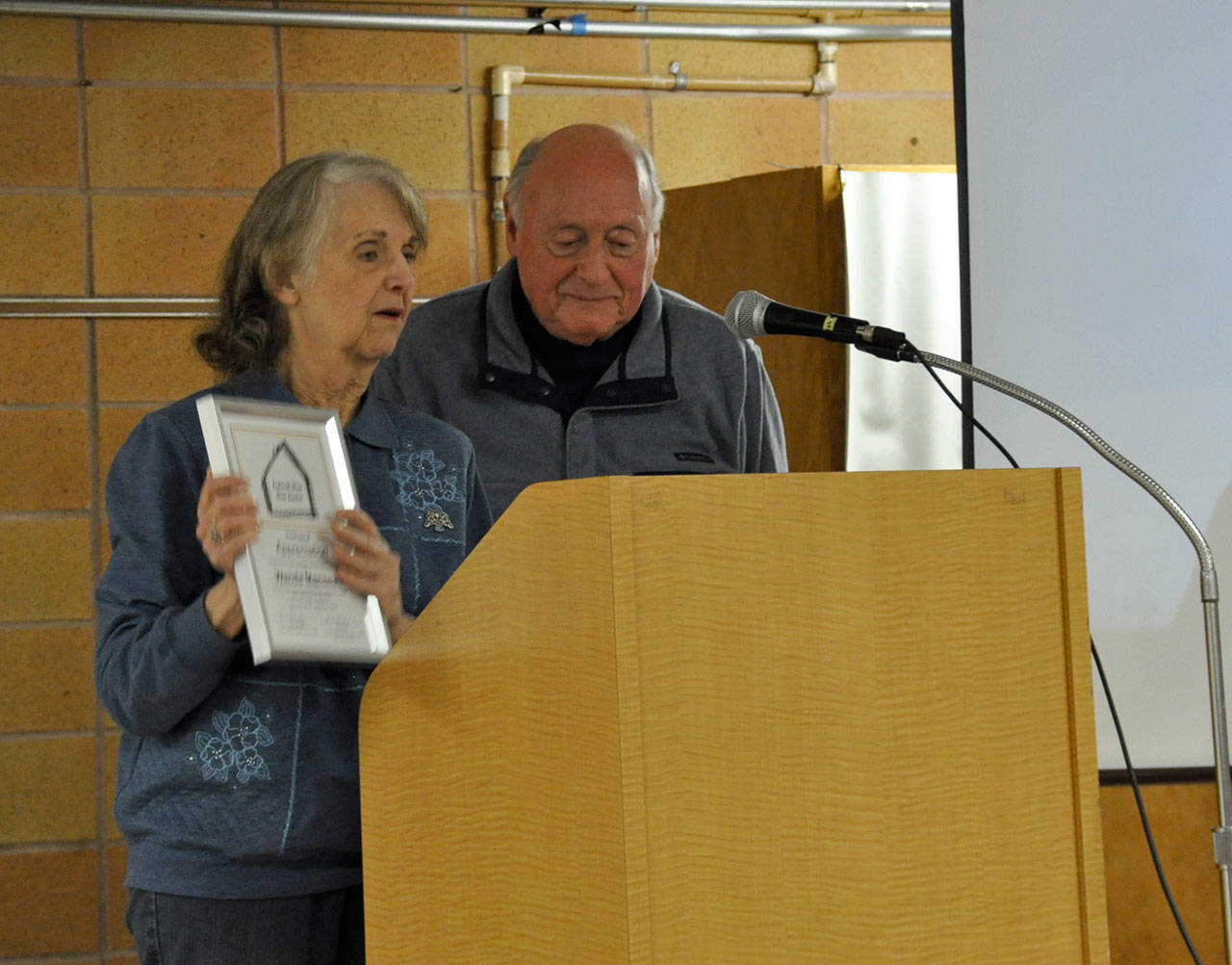Wanda Manseau, left, receives an award for her service to the Federal Way Day Center, as Ron Secreto looks on. Heidi Sanders, the Mirror