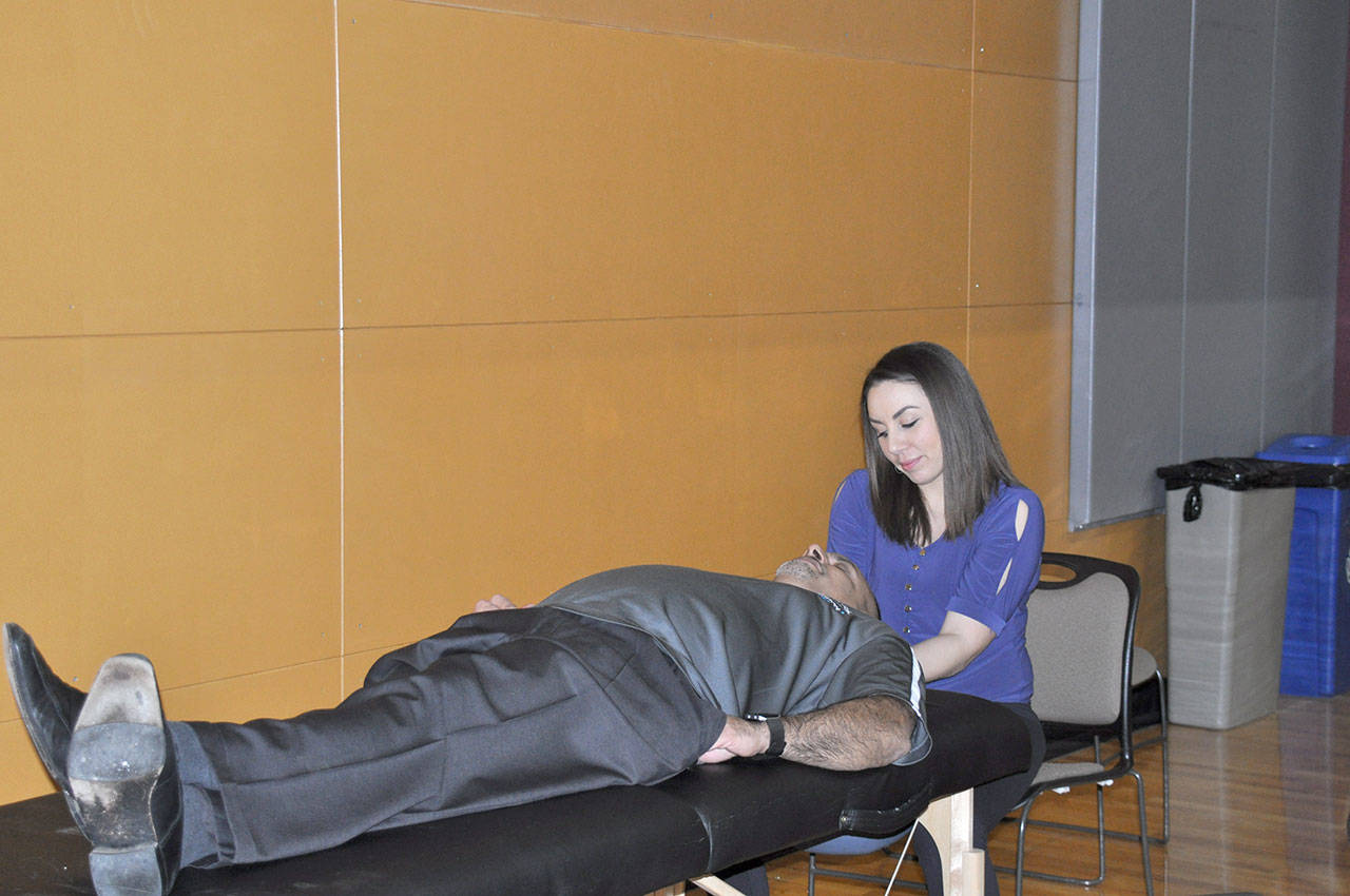 Antoinette Johnson of You’re Wellness gives Rocky Chopra a massage during the Best of Federal Way event. Heidi Sanders, the Mirror
