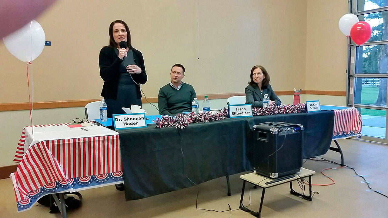 Dr. Shannon Hader, a candidate for the 8th Congressional District seat, fields a questions as her opponents, Jason Rittenreiser and Kim Schrier, look on during their debate in Auburn on March 16. ROBERT WHALE, Auburn Reporter
