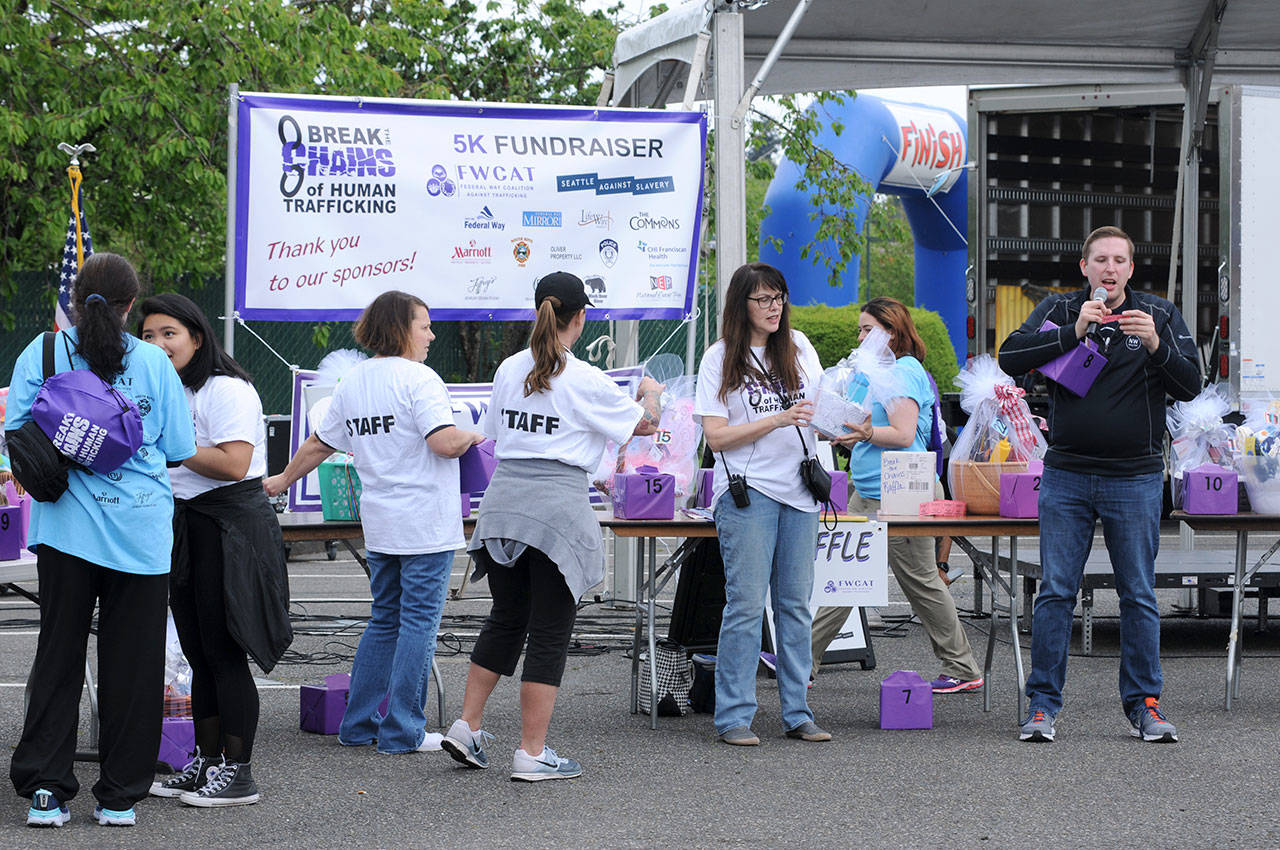 Doug Baxter, right, raffles off baskets during the Federal Way Coalition Against Trafficking’s annual Break the Chains 5K last Saturday. Baxter has served as emcee for the event for the past three years. Courtesy Shelley Pauls
