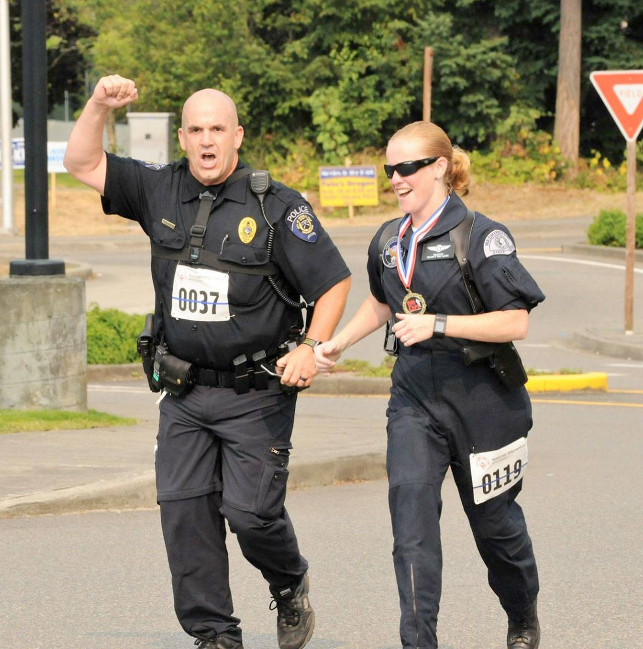 Officer Donovan Heavener, left, runs in the first annual Run with a Cop event last year. Donovan started up the event, which raises money for Special Olympics, after returning to the Federal Way Police Department in August 2016. Courtesy Shelley Pauls