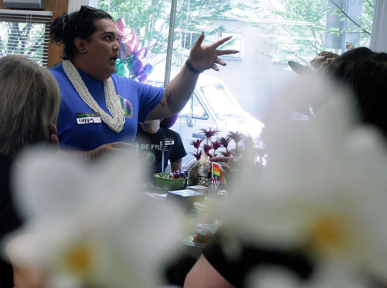 Taffy Johnson, founder and executive director of UTOPIA Seattle (United Territories of Pacific Islanders Alliance), entertains guests at the grand opening of the organization’s downtown Kent center last Saturday. MARK KLAAS, Kent Reporter