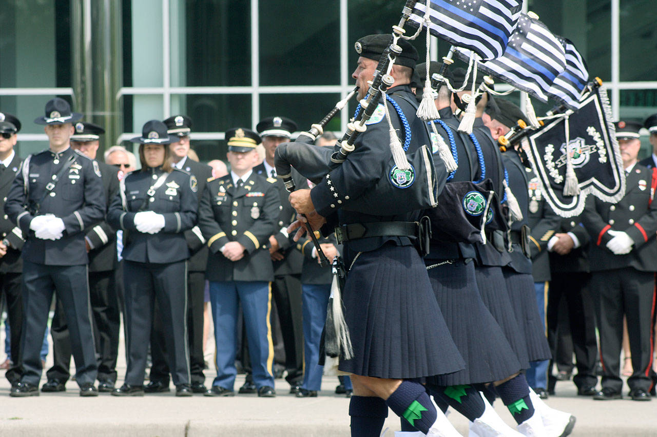 Bagpipers march in front of the accesso ShoWare Center on Tuesday prior to the memorial service for Kent Police Officer Diego Moreno. STEVE HUNTER, Kent Reporter