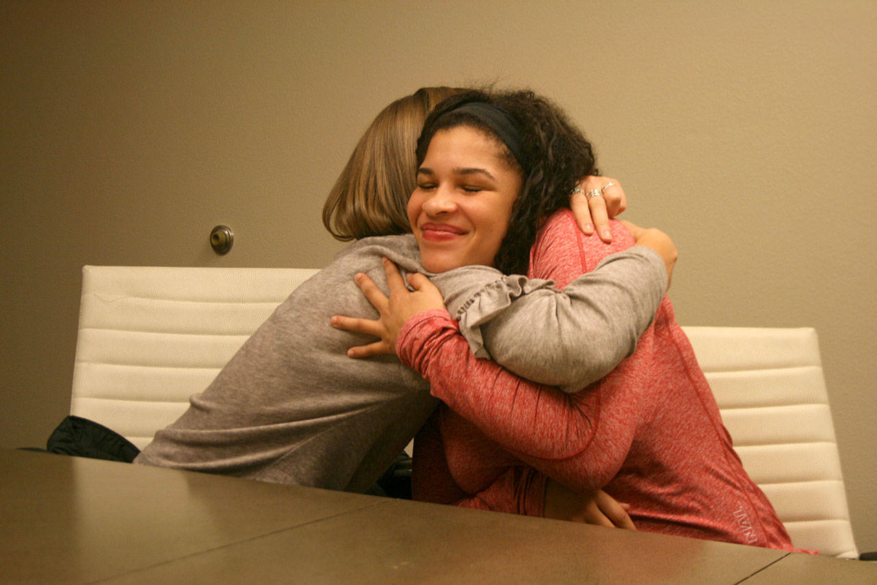 Gwen Gabert, left, and Tally Thomas embrace after sharing their stories of an alleged voyeurism scandal. Olivia Sullivan/staff photo