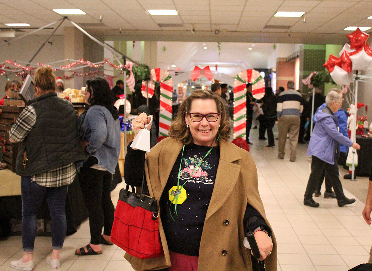 Susan Honda rallies the market goers for the performances at Candy Cane Lane. Olivia Sullivan/staff photo