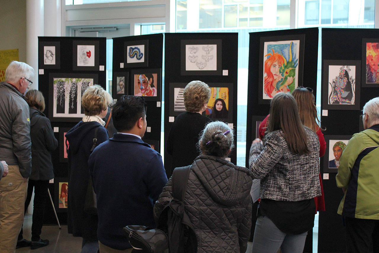Attendees view the student artworks on display. Olivia Sullivan/staff photo