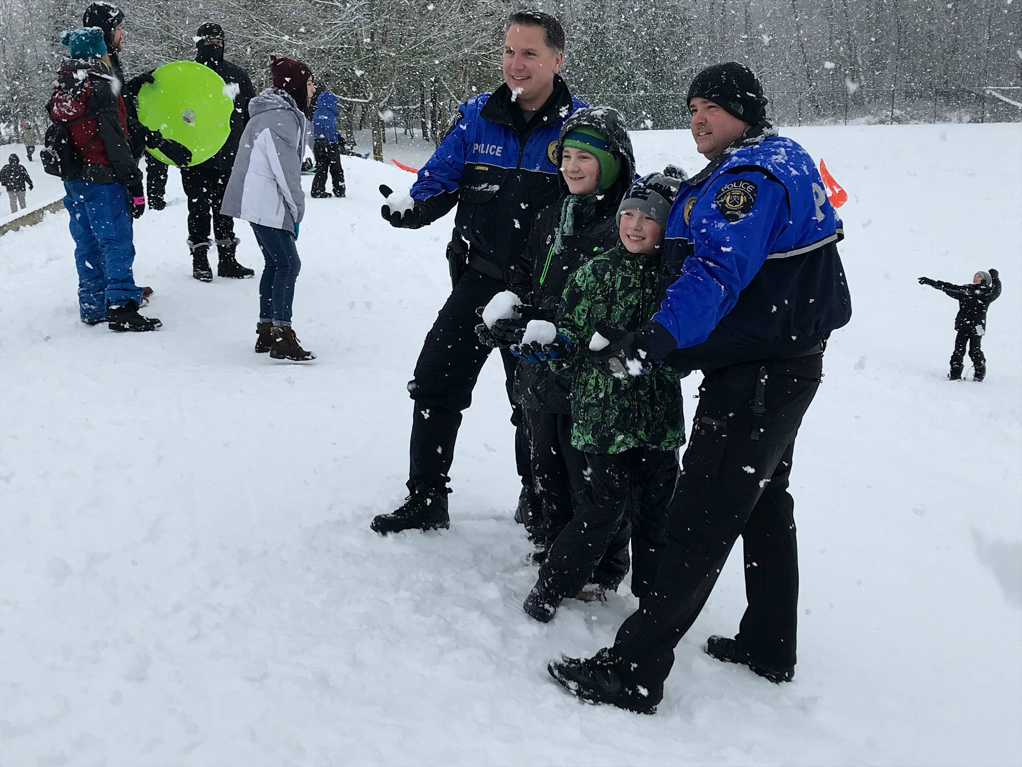 Kids and adults brought their sleds to Celebration Park and mingled with Federal Way police as the snow drifted down Monday afternoon. Photo by Andy Hobbs/the Mirror