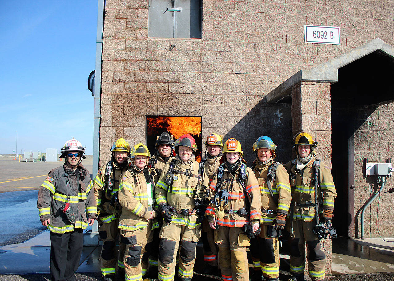 Members of Team C stand in front of the burn building at Fire Ops 101 on March 22. Courtesy photo