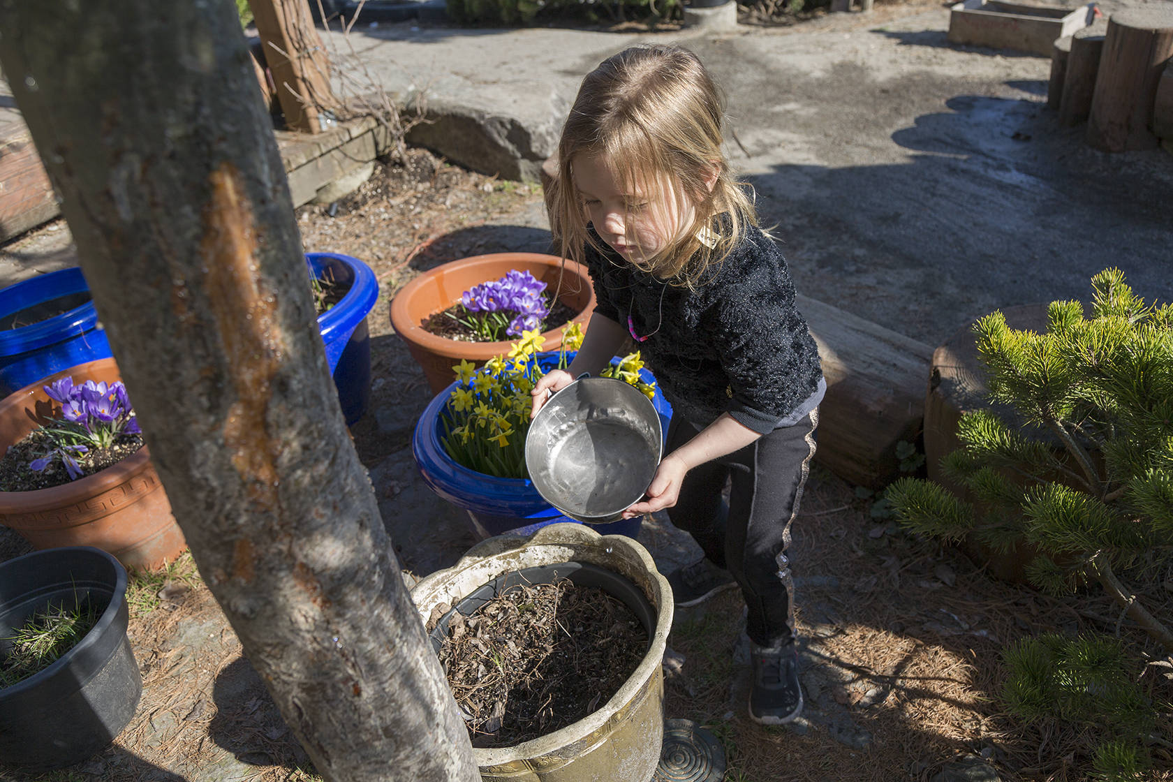 Four-year-old Emma Aasebo waters some of the plants outdoors at one of the Kiwassa Neighbourhood House’s child care centers. Ashley Hiruko/staff photo