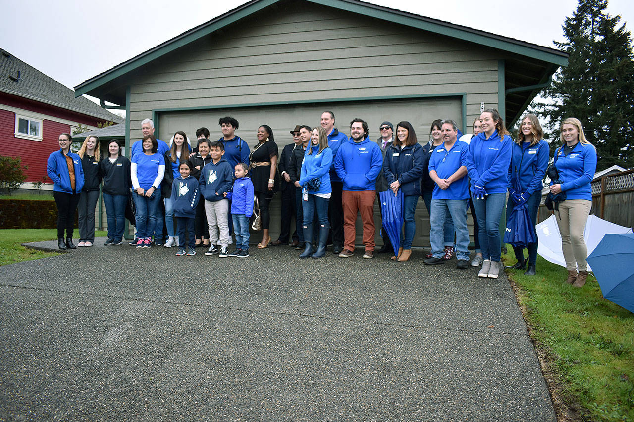 Everyone involved in making Elisa’s home ready for their move in last week gather for a photo. Pictured are FUSION volunteers, Lennar representatives, and many others who have helped during Elisa’s journey. Haley Donwerth/staff photo