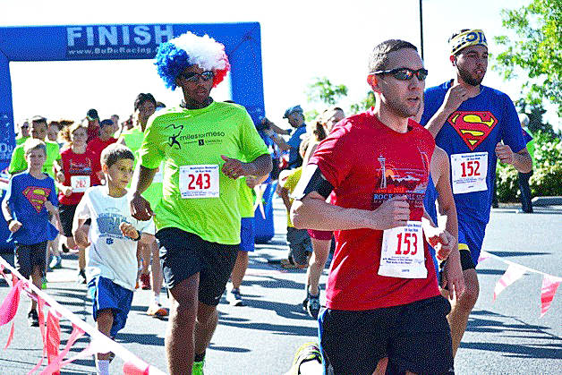 Runners cross the finish line during the annual Miles for Meso 5k on July 4 in years past. File photo                                Runners cross the finish line during the annual Miles for Meso 5k on July 4 in years past. File photo