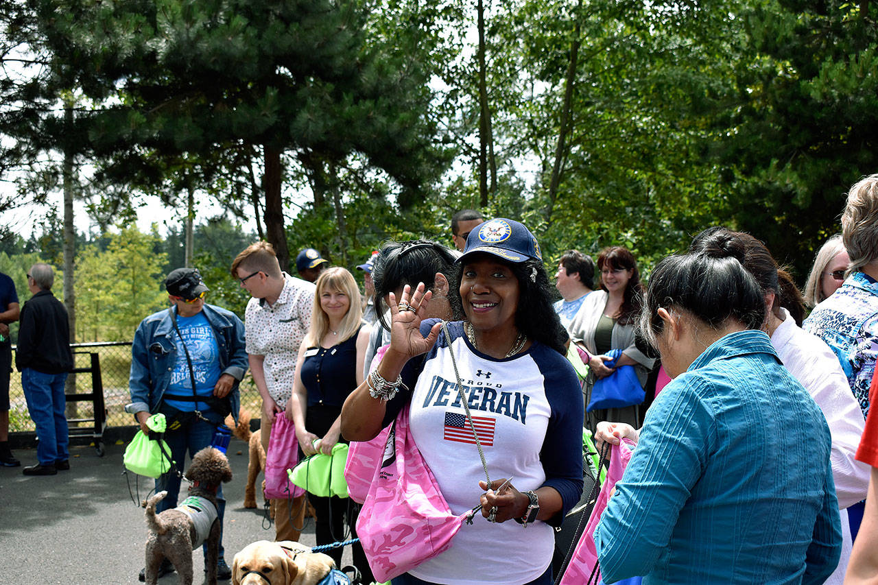 A female veteran waves to the camera during the Federal Way Vet Center barbecue that thanked women for their service to the armed forces. Haley Donwerth /staff photo