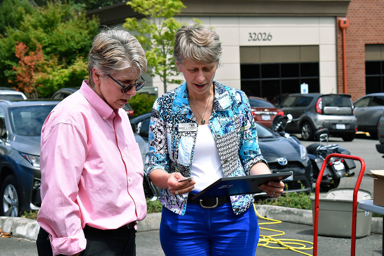 Dr. Amy Morris presents Mary Forbes with an award during the Vet Center barbecue. Haley Donwerth/staff photo