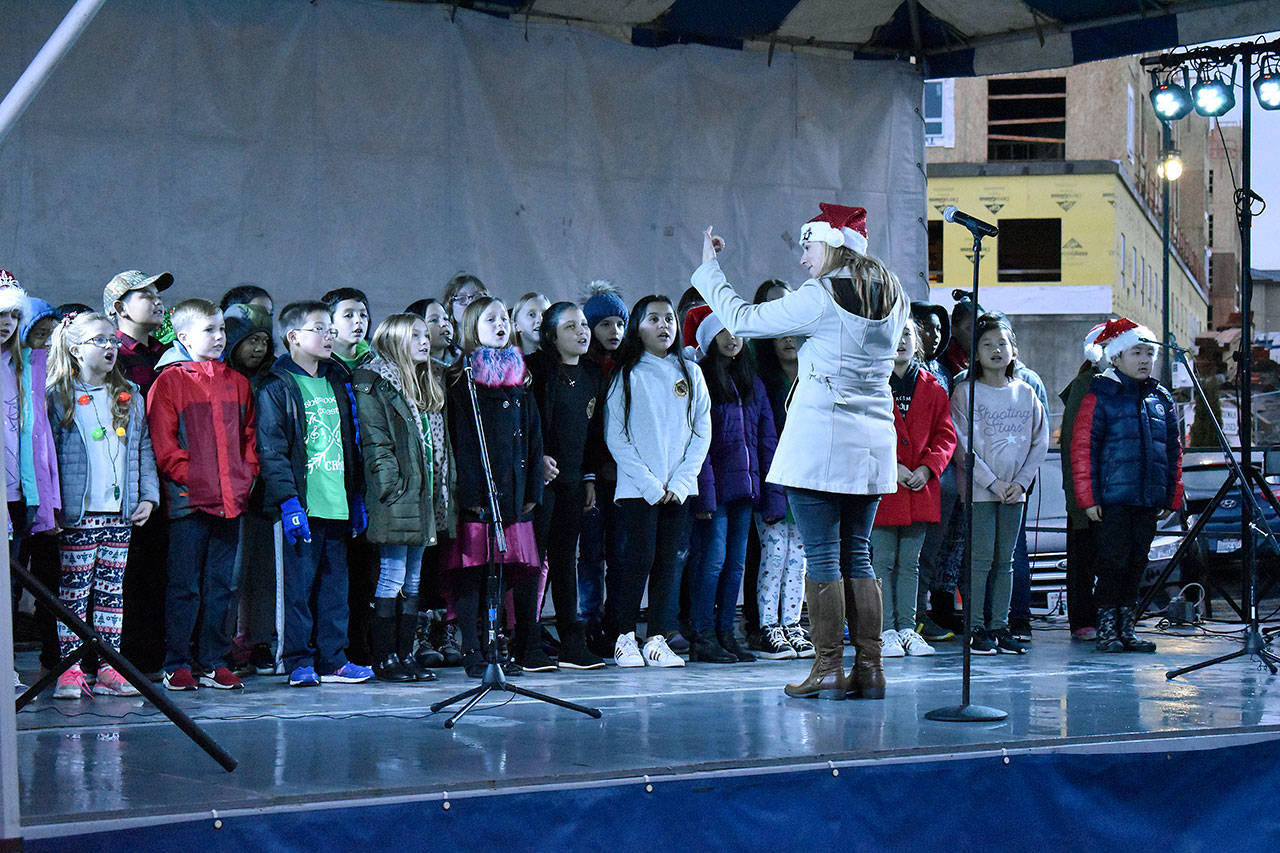 The Sherwood Forest Elementary School Choir performs some beautiful Christmas carols at the tree lighting Saturday evening. Haley Donwerth/staff photo