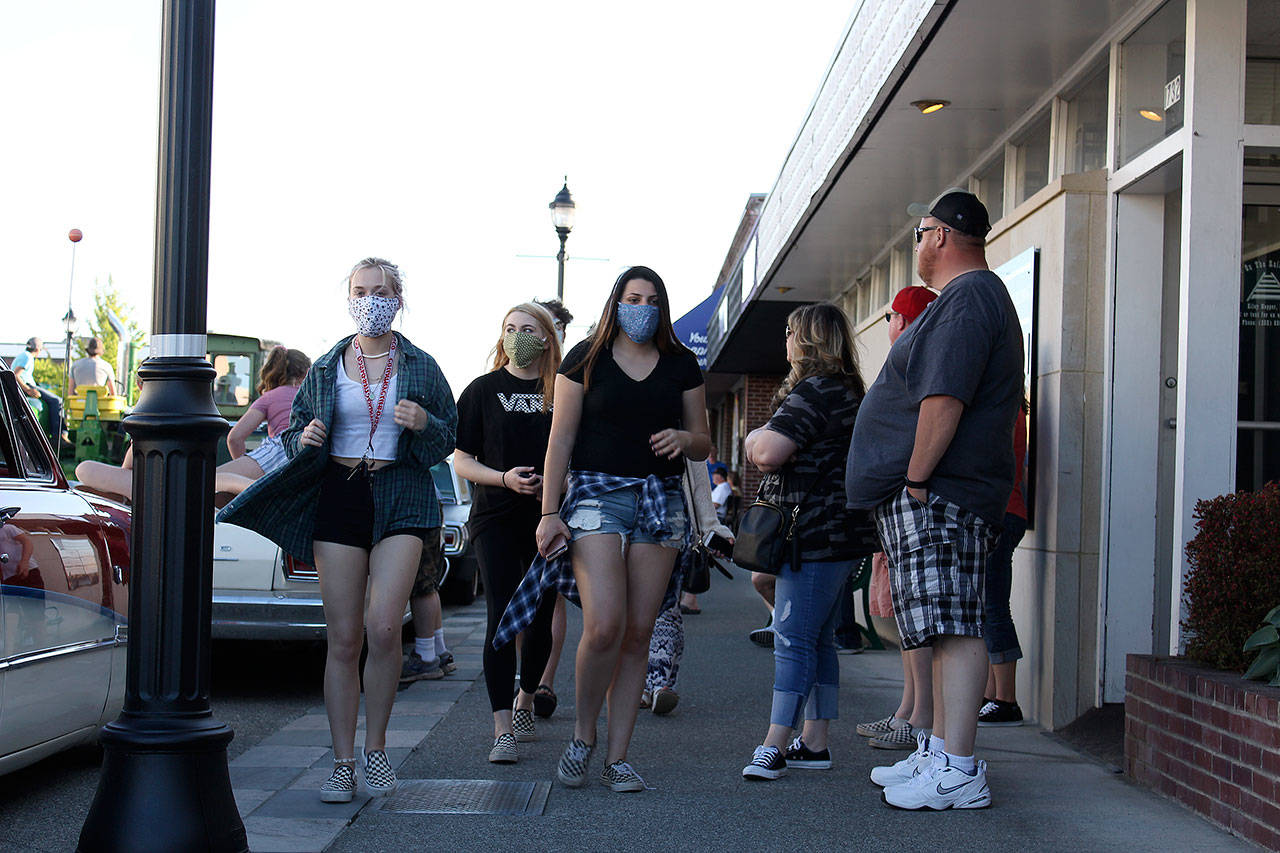 A few people wear face masks when the city of Enumclaw recently had a “downtown cruise” where people drove around downtown to order food from local restaurants. RAY MILLER-STILL, Enumclaw Courier-Herald