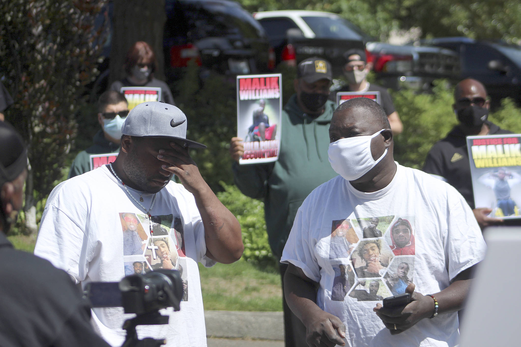 Marvin Phelps Jr., left, is overcome with emotion as he and Marvin Phelps, right, speak to the crowd at a protest in support of justice for Malik Williams on June 28. Olivia Sullivan/staff photo
