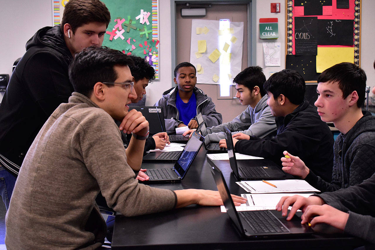 TAF@Saghalie teacher Brandon Carlisle works with his 9th grade biology students on their lab work in late February 2020. Mirror file photo