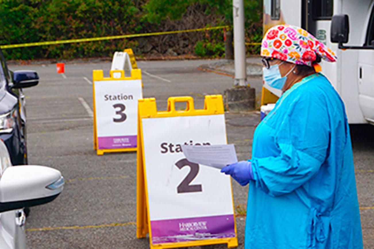 A health care worker administers a COVID-19 test in the Highline College East parking lot, where testing will take place 7 a.m. to 1 p.m. every Wednesday. Courtesy photo