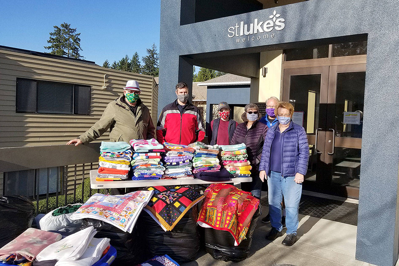 Co-leaders Betty Clifford, far right, and Marjorie Simpson, second from right, meet with Roger Flygare, Capt. Brad Chaney and Hanna Bailey of Quixote Communities on Dec. 1 to donate handmade items to organizations serving the local area. Photo courtesy of Terry Johnson of St. Luke's Lutheran Church