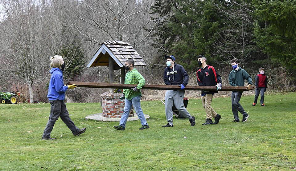 Members of Boy Scouts Troop 361 help rebuild the farm’s fence on March 6.